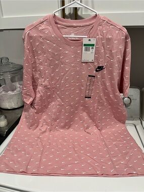 Nike Pink Short Sleeve Tee with Repeated White Swoosh Pattern